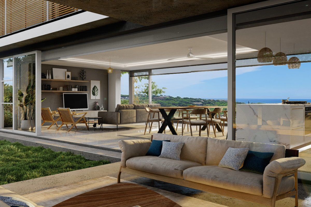 Spacious open-concept living area featuring seamless indoor-outdoor flow, modern kitchen island, and expansive sliding glass doors with coastal views.