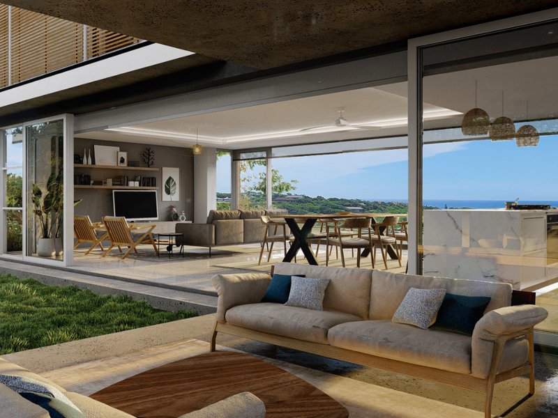Spacious open-concept living area featuring seamless indoor-outdoor flow, modern kitchen island, and expansive sliding glass doors with coastal views.