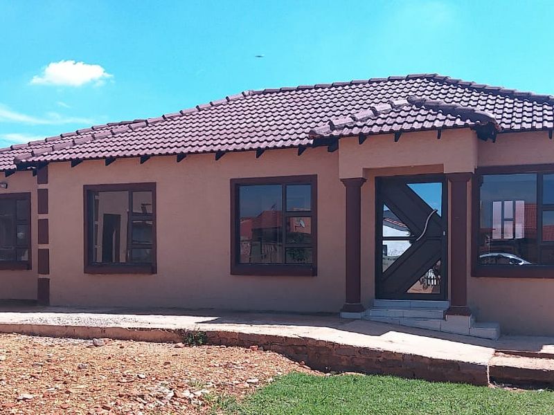 A single-story residential property featuring a tiled roof, decorative columns at the entrance, and aluminium-framed windows with a neutral exterior finish.