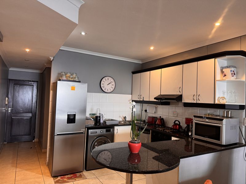 A functional kitchen featuring granite countertops, ample built-in cabinetry, a tiled backsplash, and recessed lighting, providing a practical workspace for daily use.
