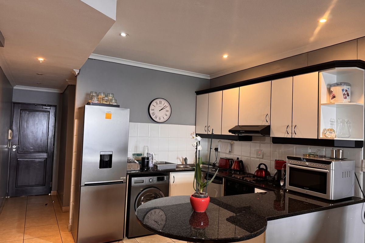 A functional kitchen featuring granite countertops, ample built-in cabinetry, a tiled backsplash, and recessed lighting, providing a practical workspace for daily use.