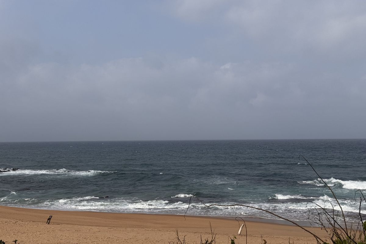A scenic view of the ocean and sandy beach coastline.
