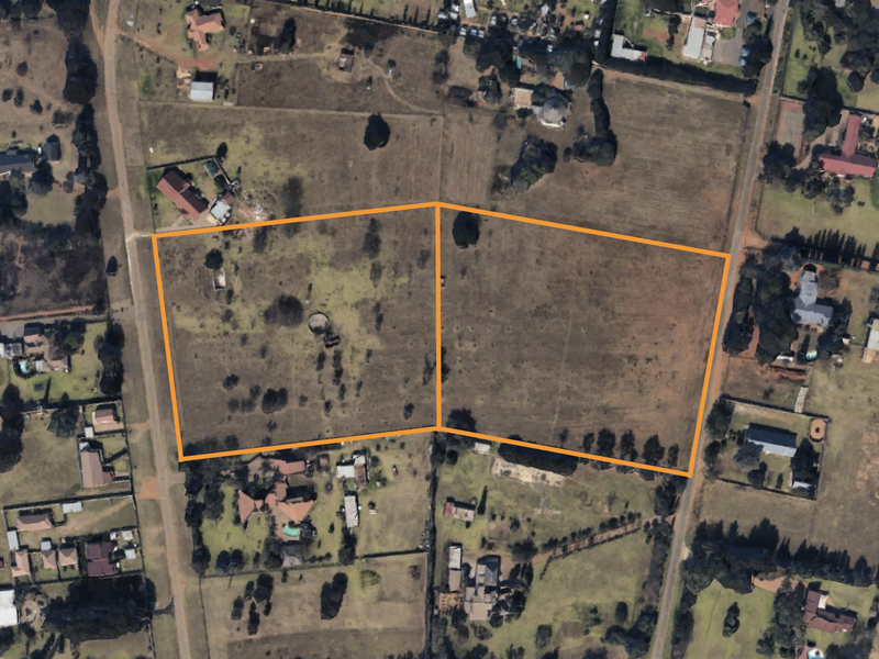 Aerial view of two adjacent vacant residential plots, highlighting the property boundaries and surrounding neighborhood landscape.