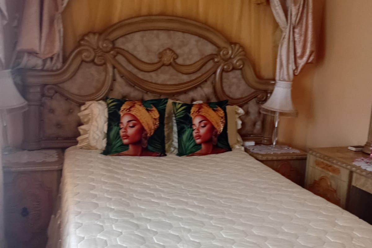 A bedroom featuring a ceiling fan and traditional decor elements.
