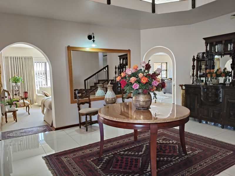 Spacious entrance hall featuring polished tile flooring and elegant arched doorways leading into adjacent living areas.