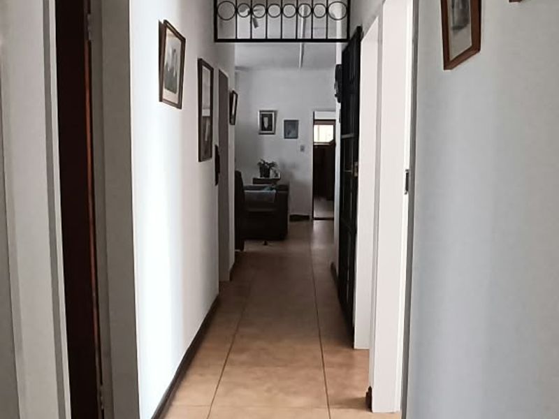 A functional hallway featuring tiled flooring and access to multiple rooms, providing a central circulation space within the home.