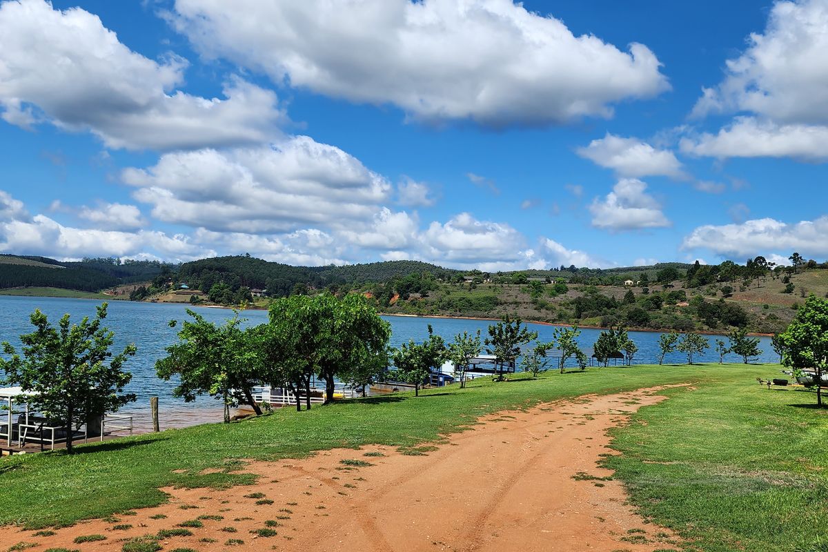 A scenic view of the waterfront featuring a grassy landscape and natural surroundings, ideal for residential development.