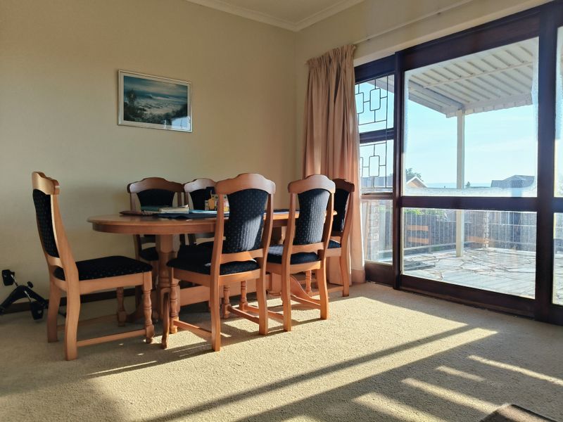 Dining room featuring carpet flooring and a large sliding glass door providing access to an outdoor patio area.