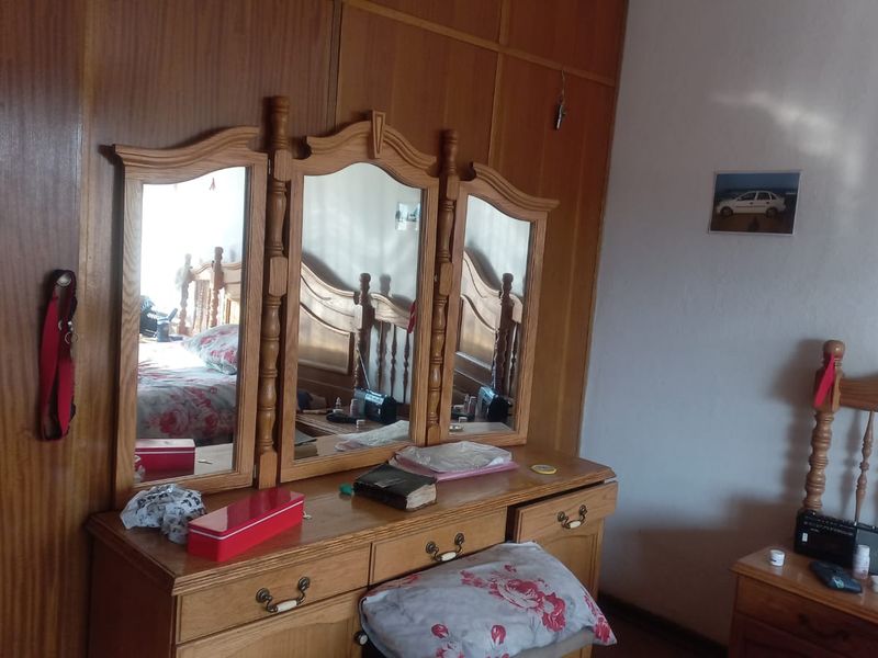 A bedroom featuring extensive built-in wooden cabinetry and storage, providing ample space for organization.
