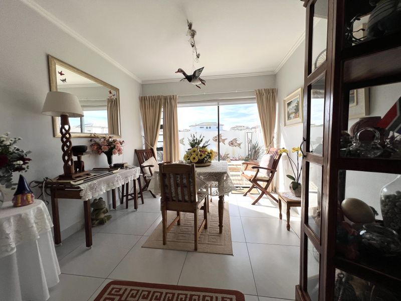 A dining room featuring tiled flooring and a sliding glass door providing access to the outdoor area.
