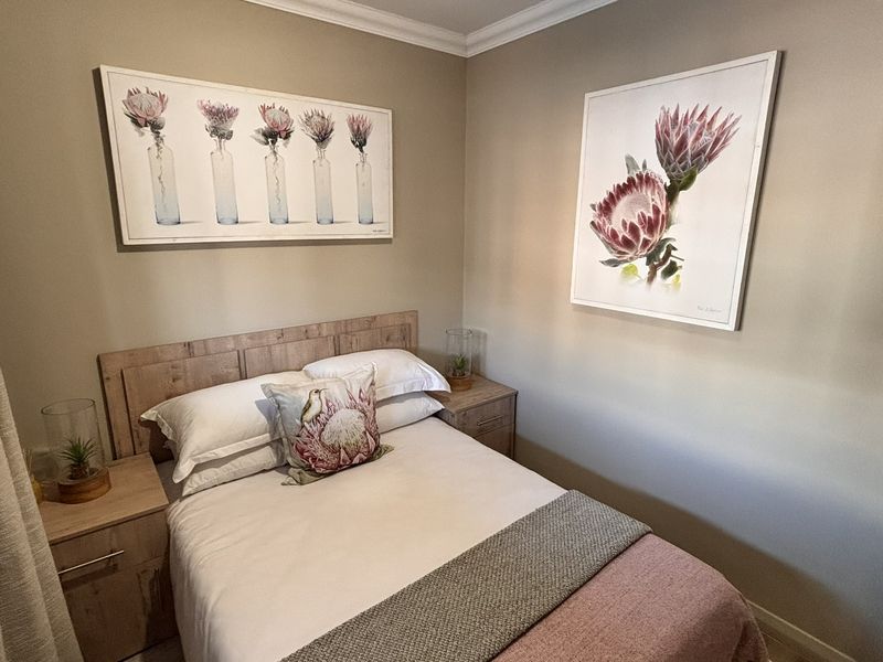 A well-maintained bedroom featuring neutral wall tones, decorative coving, and clean skirting boards, creating a comfortable and inviting living space.