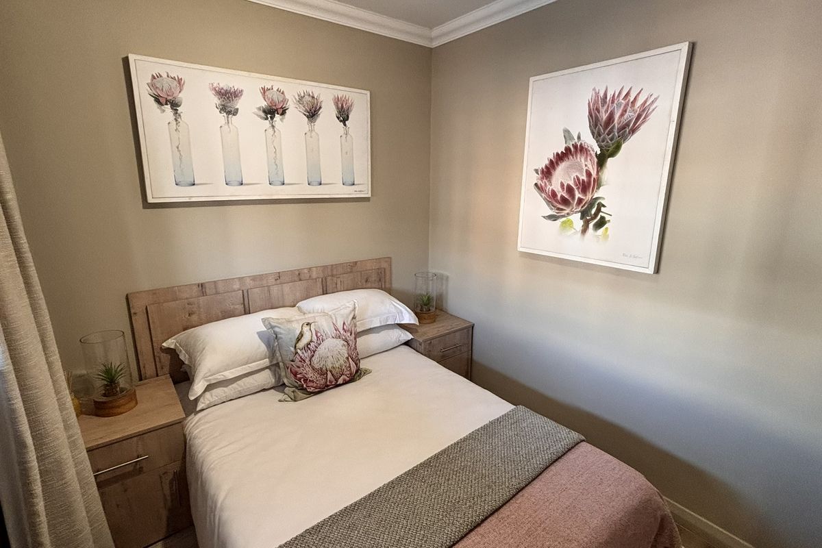 A well-maintained bedroom featuring neutral wall tones, decorative coving, and clean skirting boards, creating a comfortable and inviting living space.