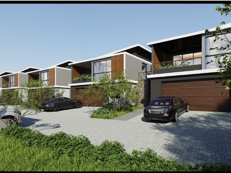 A modern residential complex featuring contemporary architectural design with paved driveways, integrated garages, and upper-level balconies.