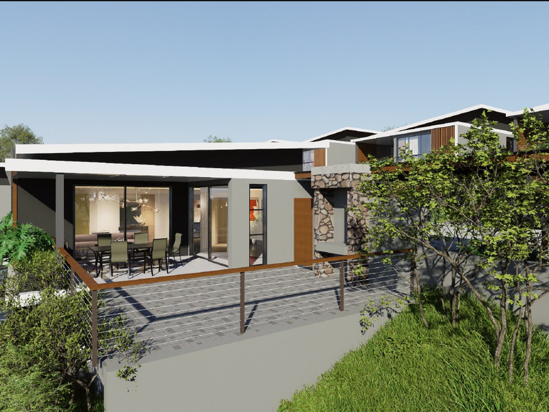 A modern rear exterior view featuring a paved patio, stone-clad outdoor fireplace, and large sliding glass doors connecting to the interior living space.