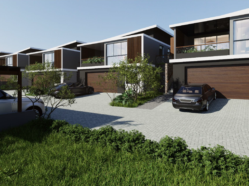 A modern residential complex featuring contemporary architectural design, paved driveways, and integrated double garages with timber-look doors.