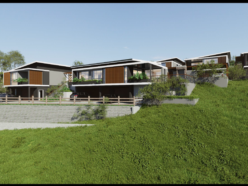 A modern multi-level residential development featuring contemporary architectural design, integrated garages, and landscaped terraced grounds.