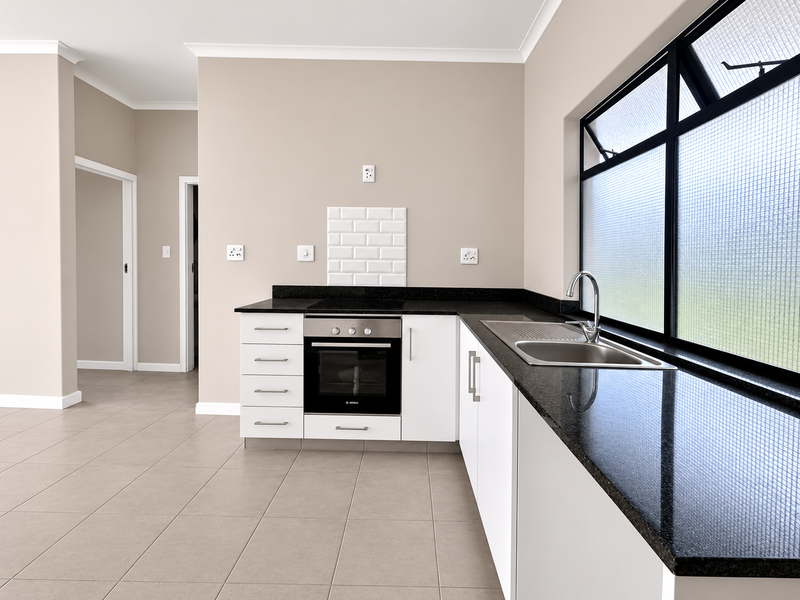 Modern kitchen featuring white cabinetry, black granite countertops, built-in oven, electric hob, and a stainless steel sink with tiled flooring.