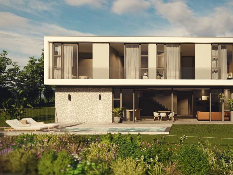 Modern two-story residence featuring a rear garden, swimming pool, stone-clad facade, and expansive sliding glass doors opening to a covered patio area.