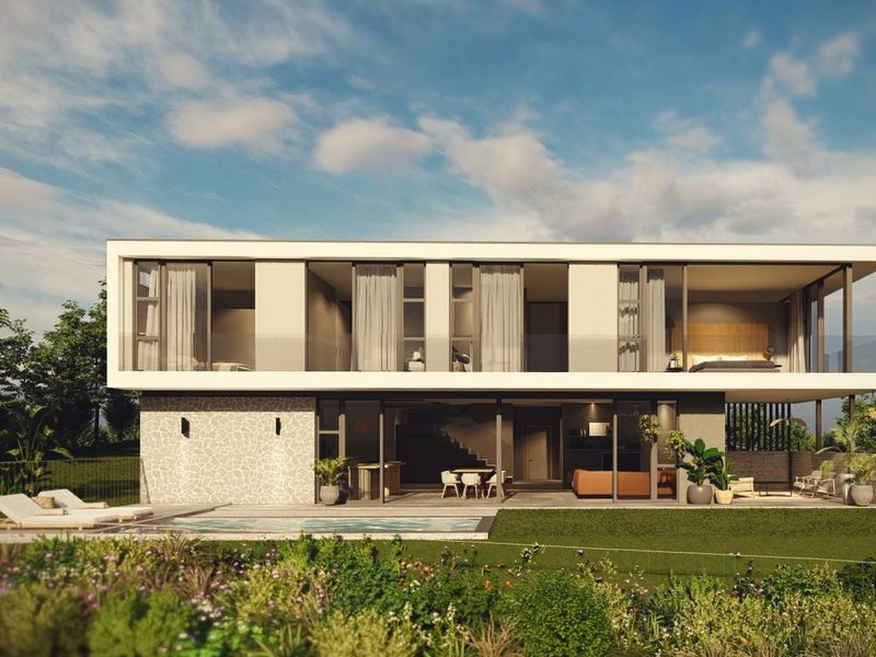 Modern two-story residence featuring a rear patio, swimming pool, and expansive glass sliding doors, showcasing contemporary architectural design and seamless indoor-outdoor living.