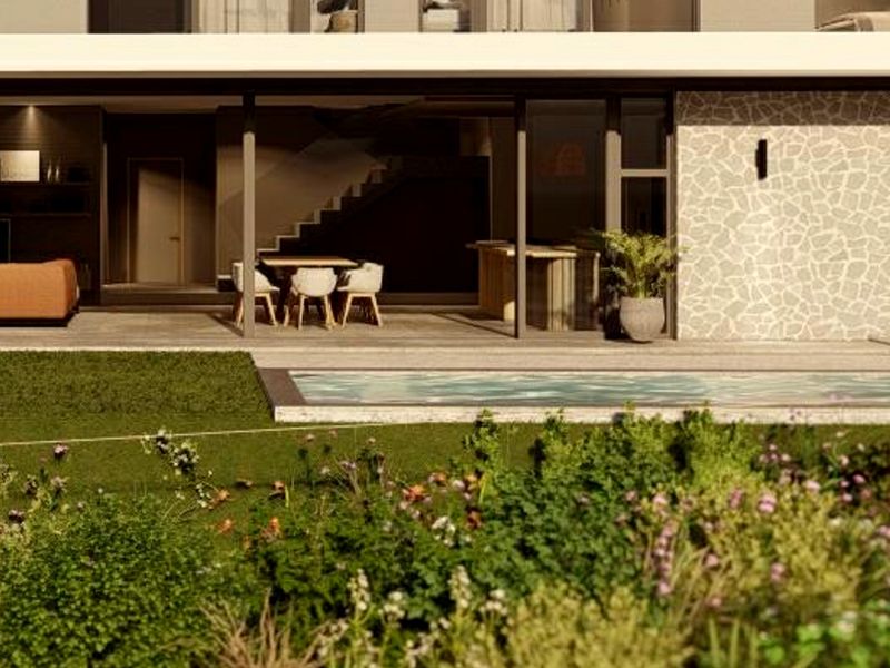 Modern rear exterior featuring a covered patio, swimming pool, and stone-clad wall, seamlessly connecting indoor and outdoor living spaces.