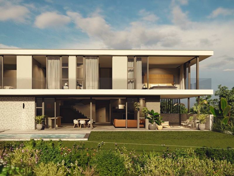 Modern two-story residence featuring a swimming pool, expansive glass sliding doors, a covered patio, and a sleek upper-level balcony with glass balustrades.
