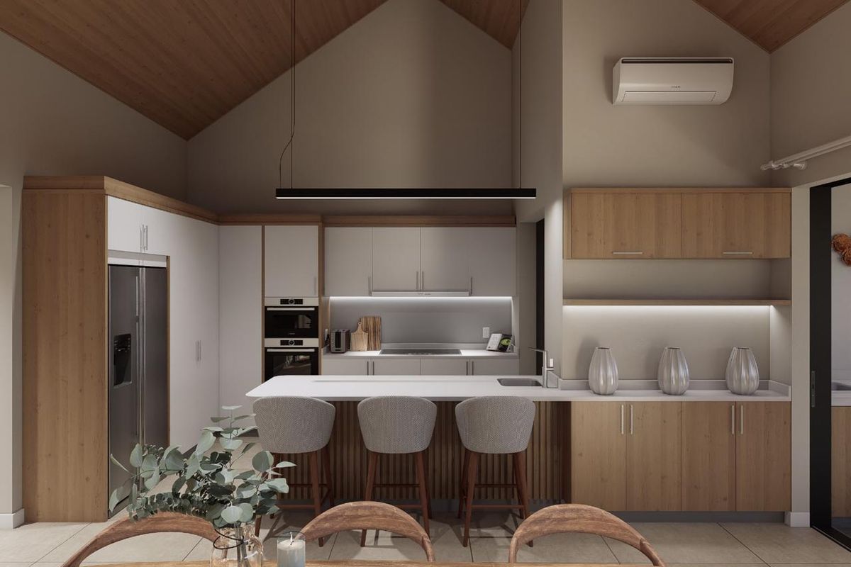 Modern open-plan kitchen featuring a vaulted timber ceiling, integrated appliances, a central island with breakfast bar seating, and sleek cabinetry with under-cabinet lighting.