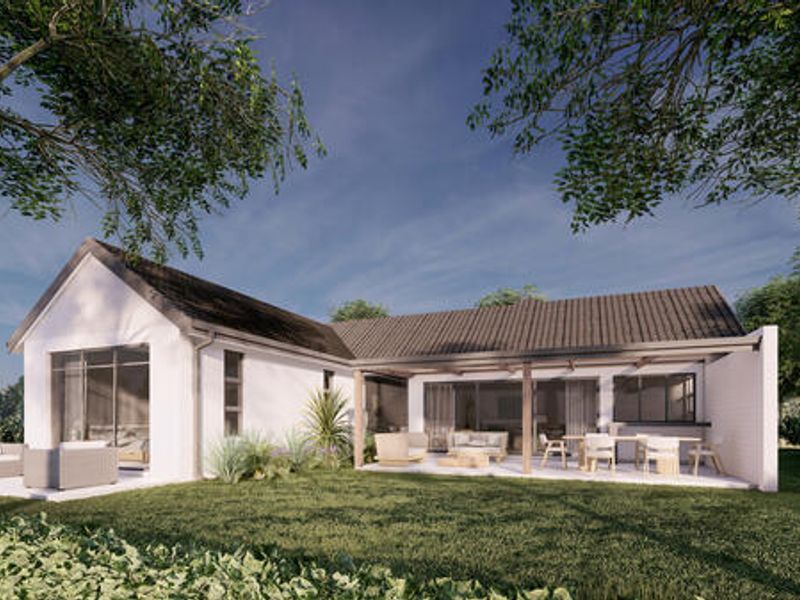 Rear view of a modern house featuring a covered patio, tiled roof, and large sliding glass doors opening onto a landscaped garden.