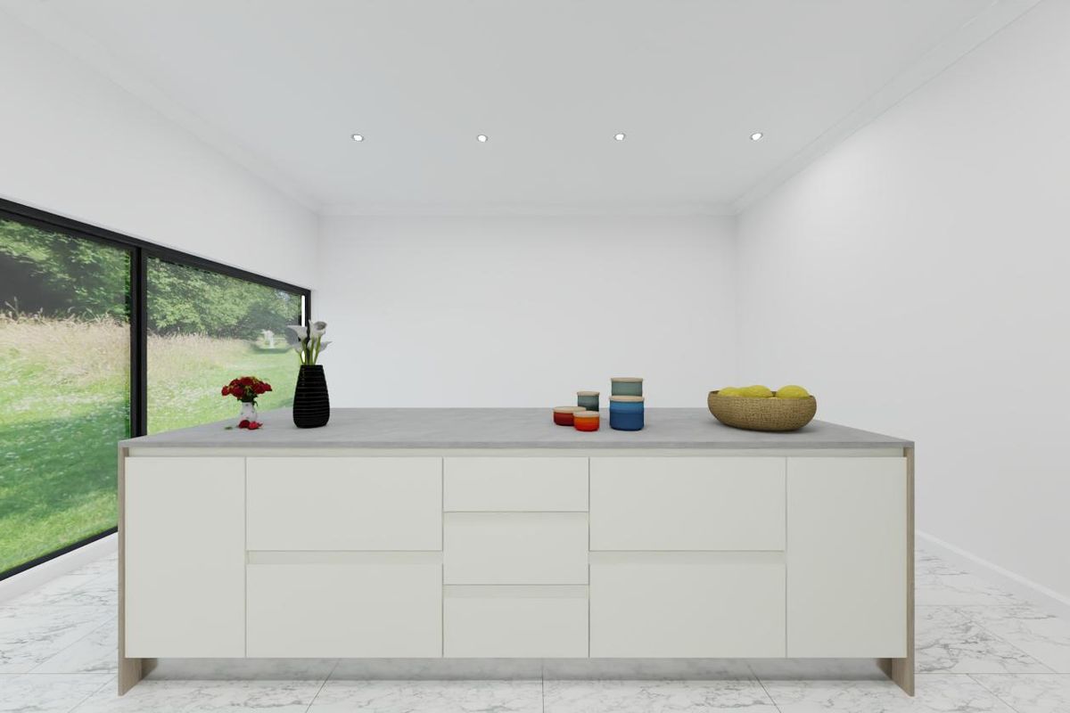 A modern kitchen island featuring a stone countertop, set against a large sliding glass door with views of the garden.
