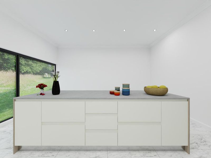 A modern kitchen island featuring a stone countertop, set against a large sliding glass door with views of the garden.