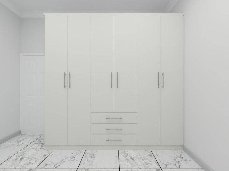 A clean, modern bedroom featuring a large white built-in wardrobe with integrated drawers and polished marble-look floor tiles.