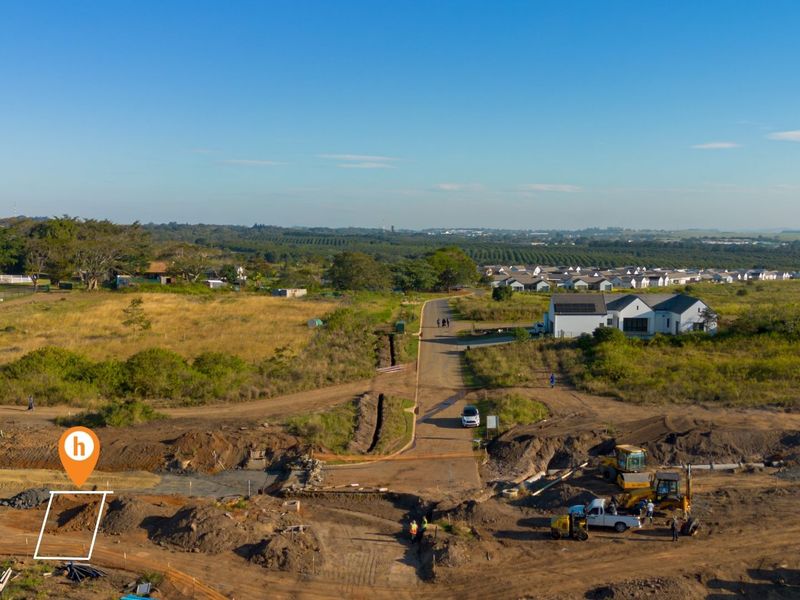 Aerial view of a residential vacant land plot under development, featuring ongoing earthworks and access to local infrastructure.
