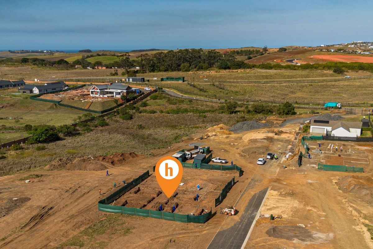 Aerial view of a residential construction site showing foundation trenches and site preparation in a developing estate.