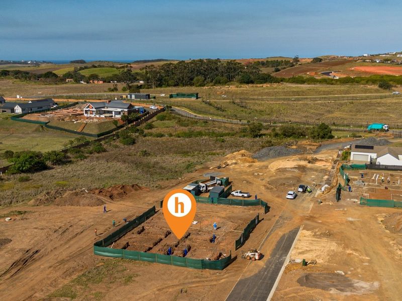 Aerial view of a residential construction site showing foundation trenches and site preparation in a developing estate.
