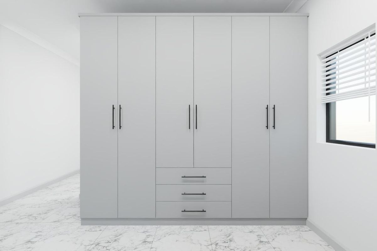 A modern bedroom featuring a large, sleek built-in wardrobe with matte grey finish, complemented by marble-look floor tiles and clean white walls.