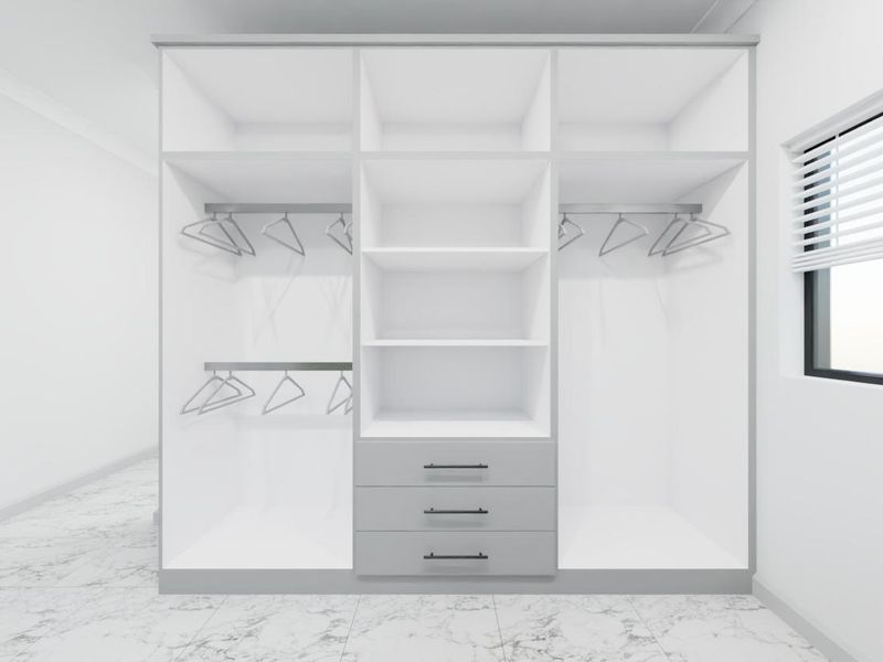 A modern, empty bedroom featuring a large, white built-in wardrobe with integrated shelving, hanging rails, and drawers, complemented by tiled flooring and a window.