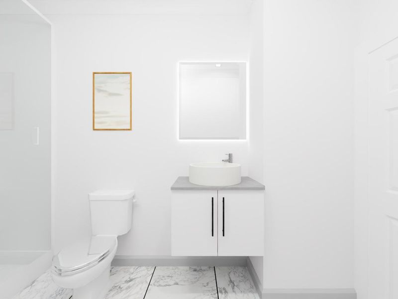 A modern, minimalist bathroom featuring a floating vanity with a vessel sink, backlit mirror, toilet, and a glass-enclosed shower with marble-look flooring.