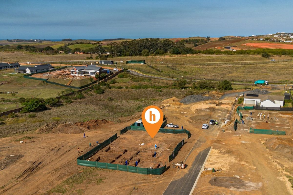 Aerial view of a residential construction site showing foundation trenches and site preparation within a developing estate.