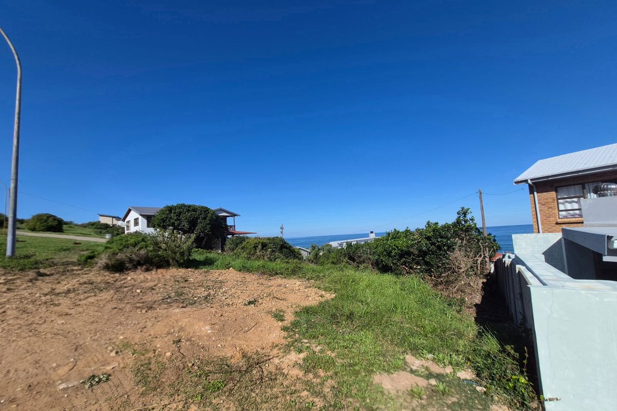 A view of the coastal landscape and ocean from the vacant residential plot, showcasing the surrounding neighborhood and natural scenery.