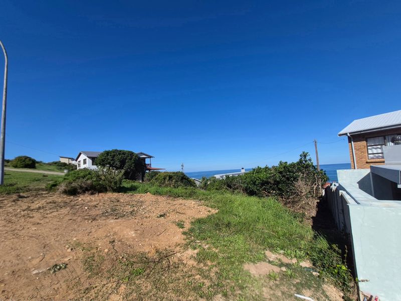 A view of the coastal landscape and ocean from the vacant residential plot, showcasing the surrounding neighborhood and natural scenery.