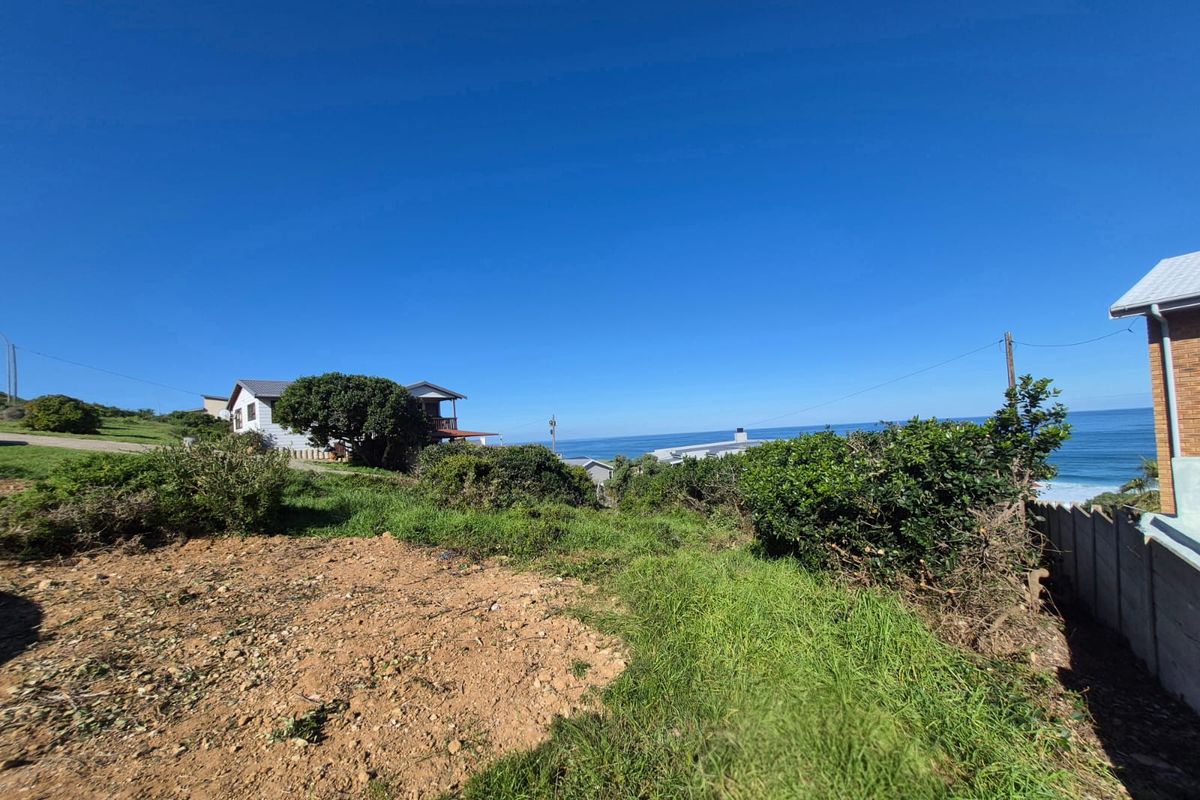 A scenic view overlooking the coastline and ocean from the residential land plot, showcasing the natural landscape and surrounding neighborhood.