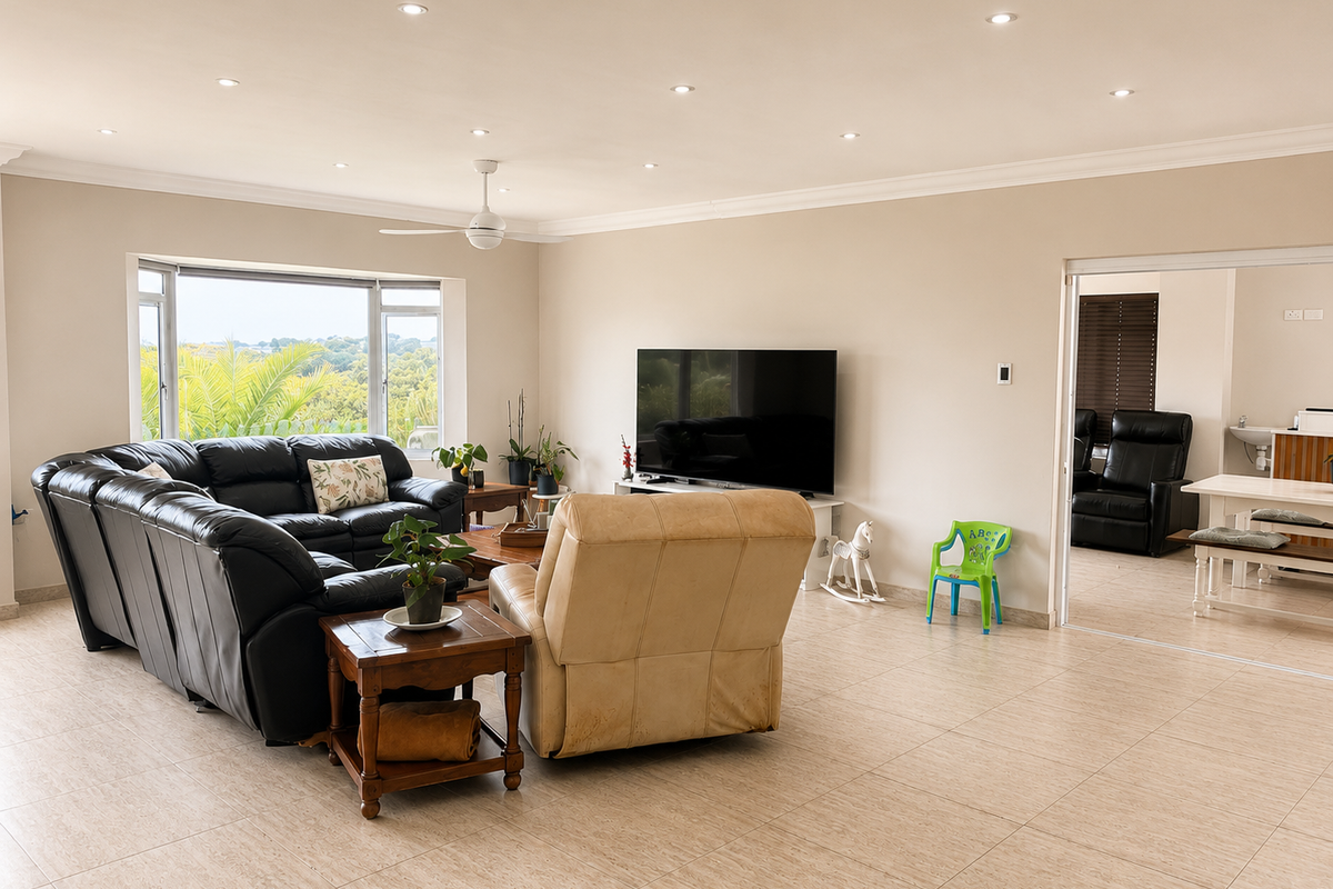 Spacious living room featuring neutral tiled flooring, recessed downlighting, a ceiling fan, and a large bay window with natural light.