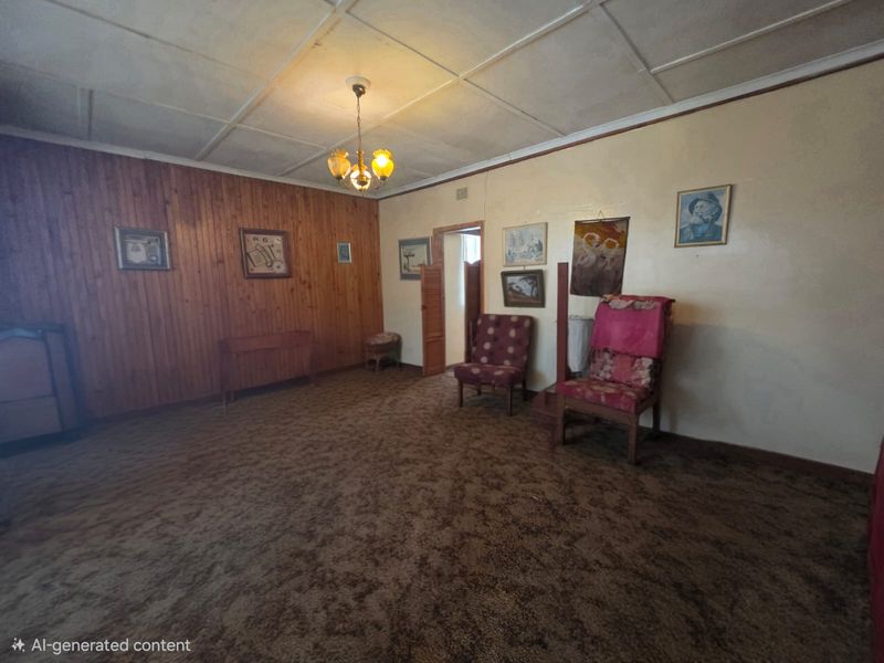 A dated living room featuring timber wall paneling, tiled ceiling, and original carpeting, offering significant potential for modernization and renovation.