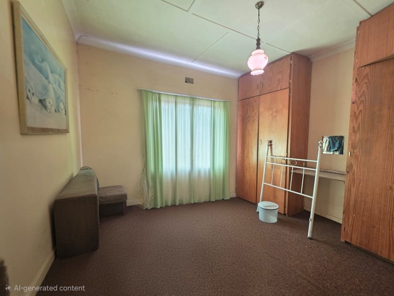 A bedroom featuring built-in wooden cupboards, carpeted flooring, and a pendant light fixture, offering a dated interior ready for modernization.