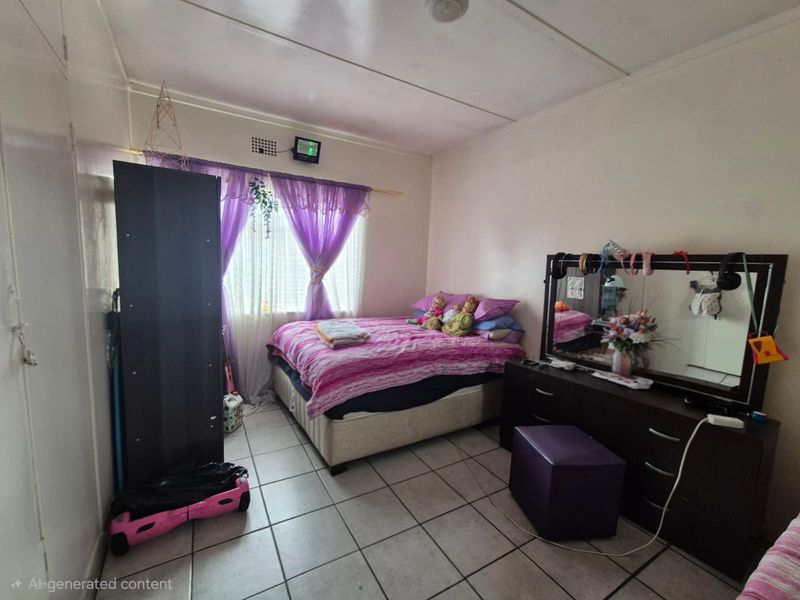 A standard bedroom featuring tiled flooring and a ventilation brick, providing a functional space for rest.