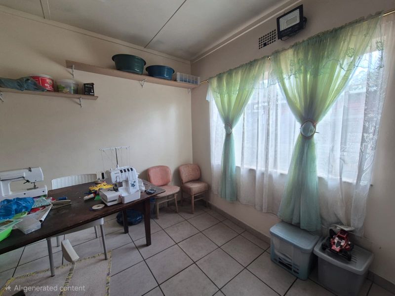 A functional bedroom space featuring tiled flooring and wall-mounted shelving, currently utilized as a hobby room.
