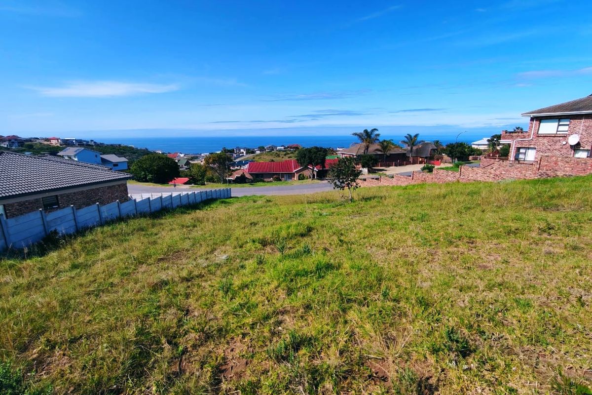 A view of the vacant residential land looking out towards the surrounding neighborhood and distant ocean horizon.