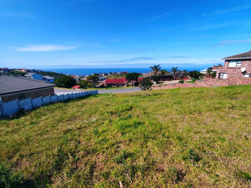 A view of the vacant residential land looking out towards the surrounding neighborhood and distant ocean horizon.