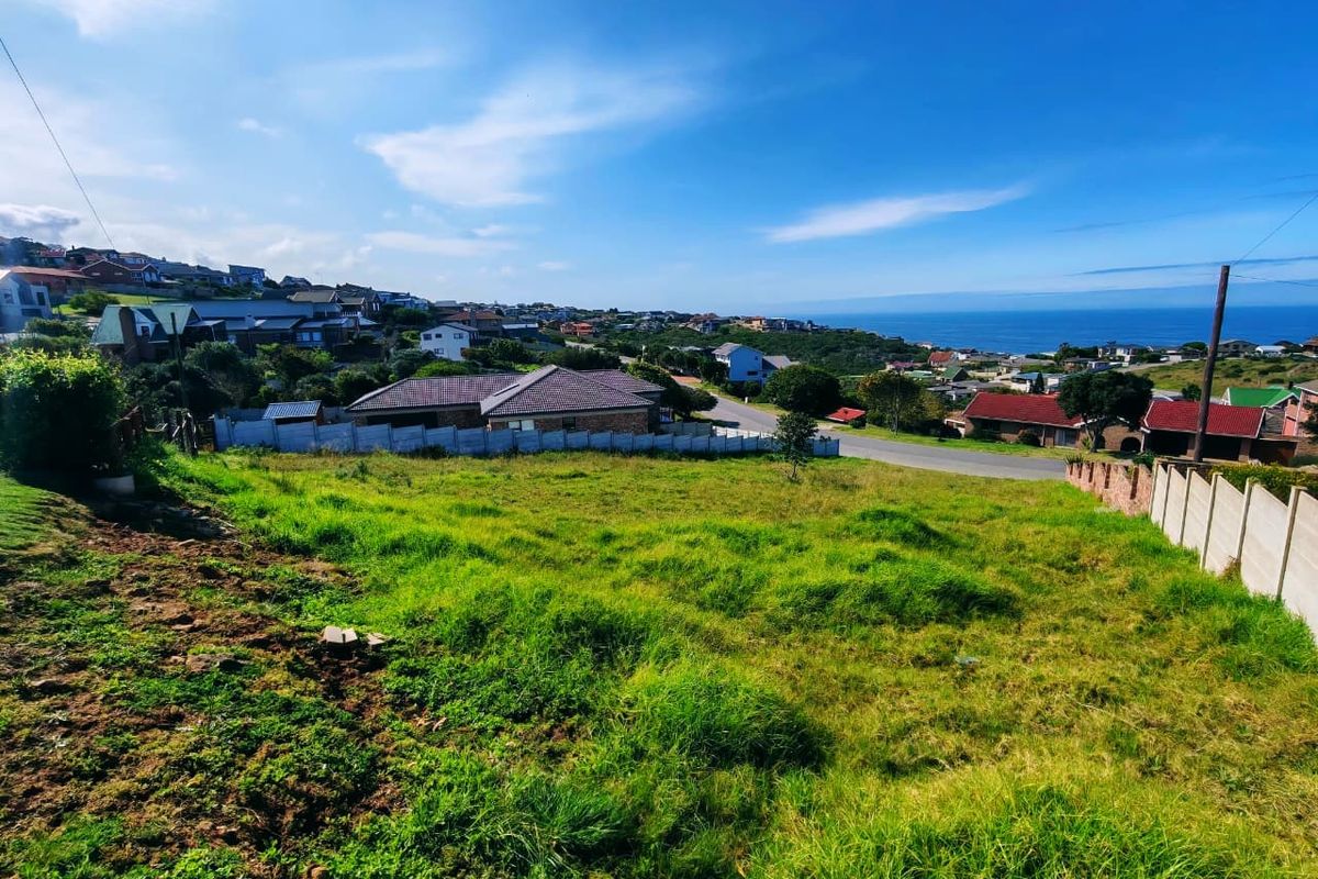 A vacant residential plot featuring a gentle slope, enclosed by precast concrete boundary walls, offering scenic coastal and neighbourhood views.