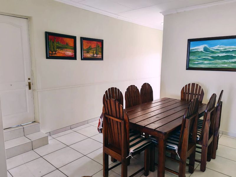 A dining area featuring tiled flooring and neutral walls, providing a functional space for family meals.