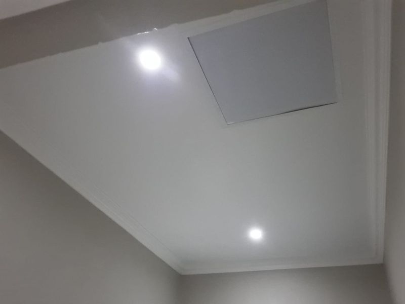 A view of a ceiling featuring recessed downlights, decorative coving, and a ceiling access hatch.